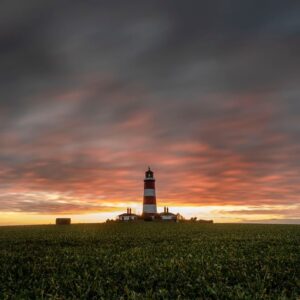 happisburgh lighthouse in norfolk with a red sky at sunset